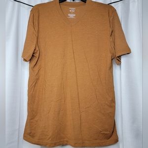 Brand new. Rust colored V neck shirt